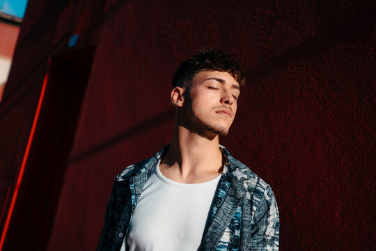 Portrait of introspective young man with eyes closed