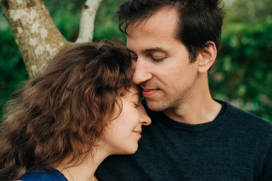 Close-up of couple touching foreheads in peaceful moment