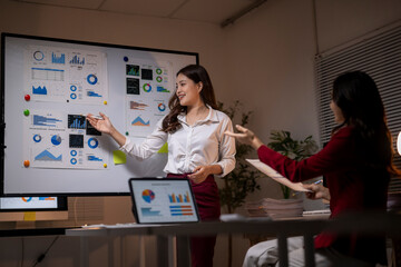 Business women presenting data analysis during late night meeting