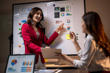 Businesswomen analyzing data charts during an office meeting