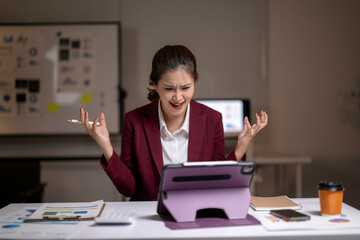 Frustrated businesswoman experiencing work stress and burnout in office