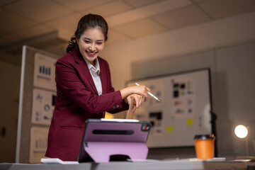 Asian businesswoman laughing while having video conference