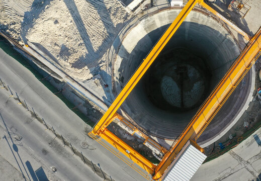 Large Yellow Construction Crane Tower Working Over a Tunnel Shaft