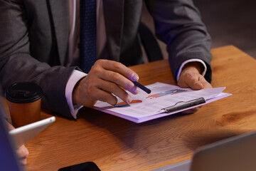 Male business analyst working in office at night, closeup. Data science concept