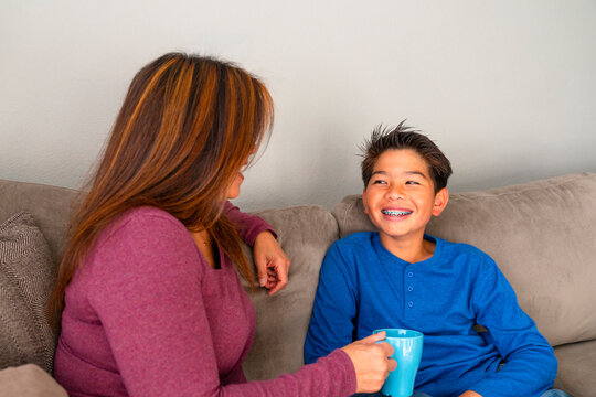 mom and teenage son talking at home 