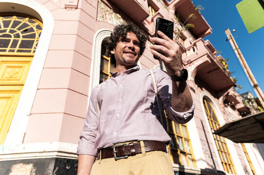 Modern traveler connecting online in  inspiring colonial street