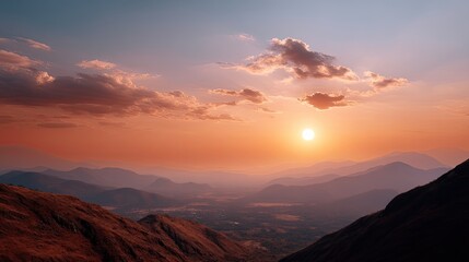 Obraz premium Serene Mountain Landscape at Sunset with Vivid Colors and Silhouetted Peaks Under a Colorful Sky Overlooking Vast Valleys and Rolling Hills