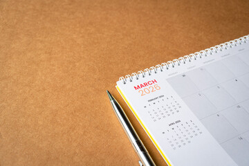 March 2026 calendar on top of brown surface.