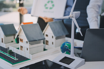 Hands of adult Asian business professionals analyzing ESG financial data and renewable energy project plans