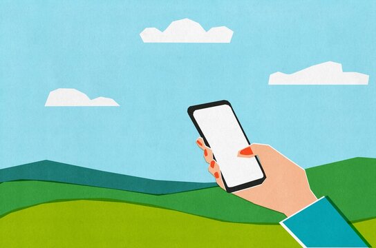 Holding a Smartphone in a Green Landscape Under Blue Skies