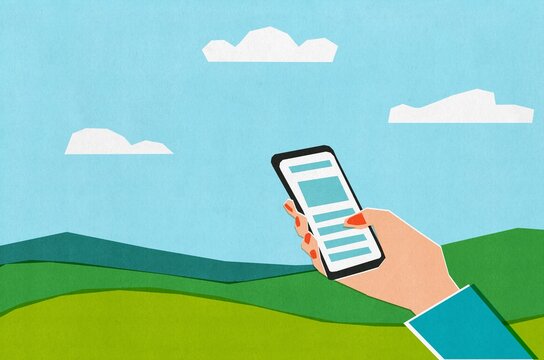 Holding a Smartphone in a Green Landscape Under Blue Skies
