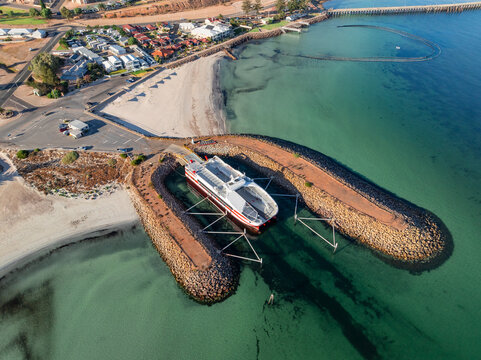 Modern ferry boat at anchor in protective rock breakwalls
