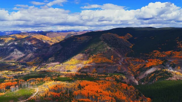 Gilman ghost town Mount of the Holy Cross Wilderness Sawatch Gore Range Minturn Red Cliff Vail aerial drone Fall Autumn cloudy morning Rocky Mountains Colorado colorful Aspen trees circle left motion