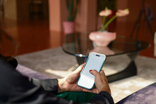 Anonymous woman scrolling on blank screen .
