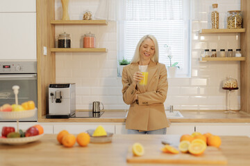 Woman enjoying a glass of fresh orange juice