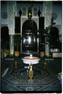 Film photo of a beautiful Moroccan courtyard with a fountain