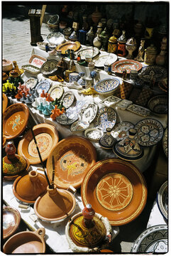Film photo of colorful pottery market display in vibrant sunlight
