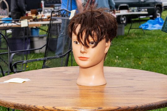 Mannequin Head with Messy Hair on Table at Flea Market  
