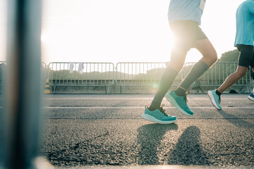Runners Participating in a Marathon During Sunrise in a City
