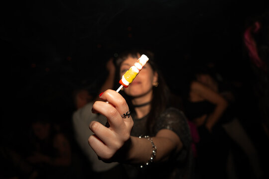 Woman holding colorful lollipop and smiling