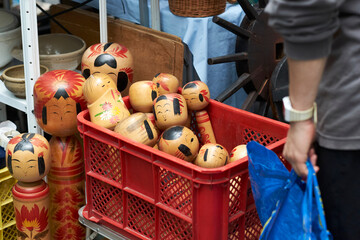 Colorful Wooden Kokeshi Dolls for Sale at an Open Market