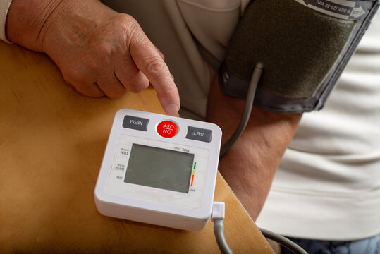 Anonymous woman measures her blood pressure herself