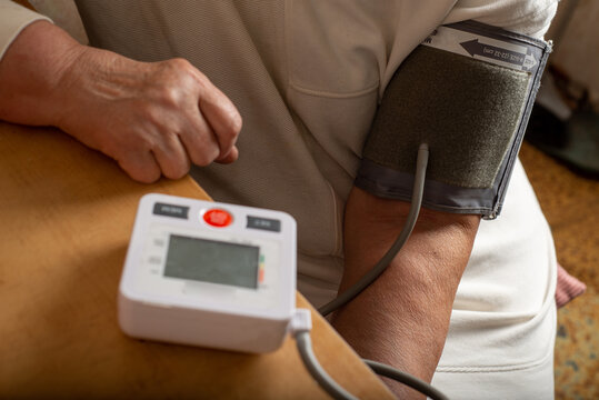 Anonymous woman measures her blood pressure herself