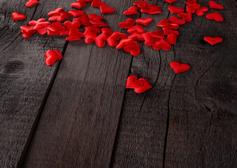 Red Hearts Scattered on Wooden Background Symbolizing Love and Passion. Valentines Day and Love Wallpaper Background.
