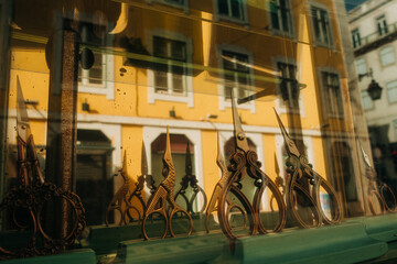Vintage scissors on display with building reflection