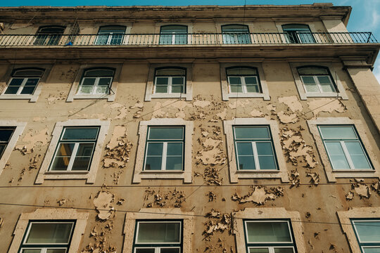 Weathered old building with peeling facade under blue sky