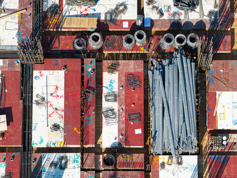 Aerial View of Construction Site with Rebar and Building Materia