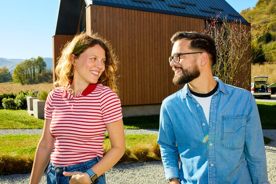 Couple facing each other in front of the cabin