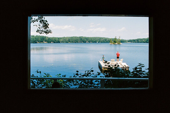 View through window of family lake vacation