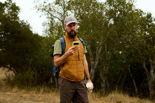 Hiker uses smartphone in nature