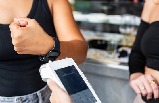 Anonymous woman makes contactless payment by smartwatch