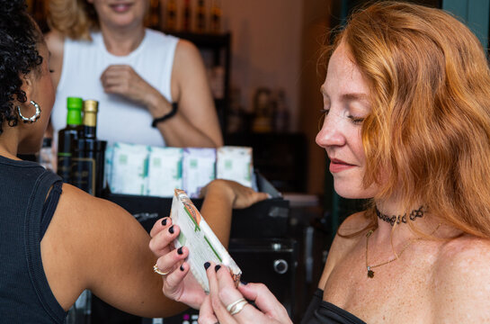 Woman Examining a Snack at a Local cafe 