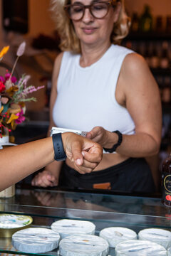 Anonymous woman makes a contactless payment using smartwatch