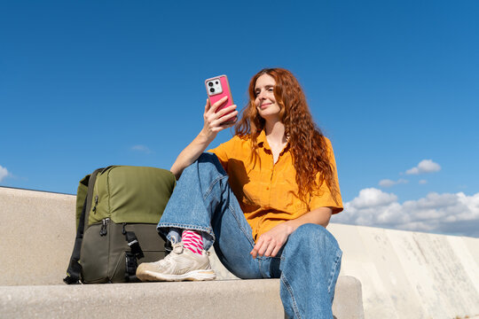 Happy woman with phone blue skye