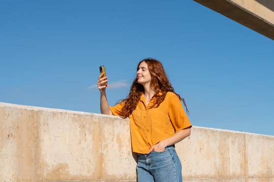Happy woman with phone blue skye