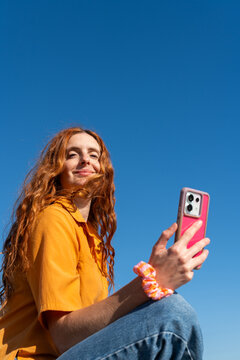 Woman phone sunny day 