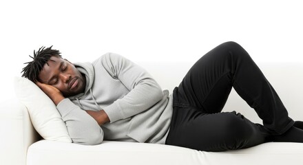 Obraz premium A man sleeping on a white couch with a pillow.
