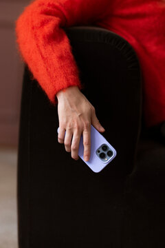 Close-Up Of Hand Grasping Lavender Smartphone