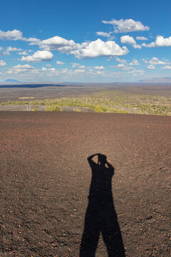 Photographer's shadow from desert hilltop