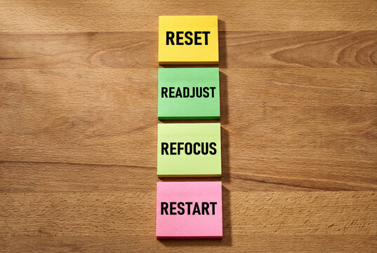Reset readjust refocus restart wooden blocks motivation. Success business strategy change improvement development stack beige desk.