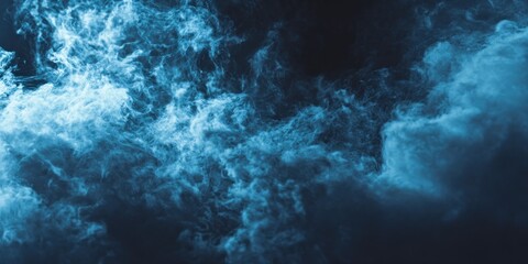 Obraz premium A swirling cloud of blue smoke against a dark background, creating an ethereal and dynamic visual effect.