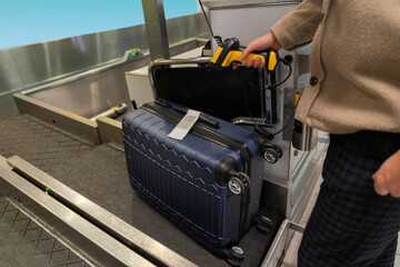 Anonymous Man Scans Luggage at Airport Self Drop off Station