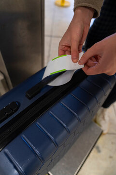 Man Tags Luggage at Airport Self Drop Service Before Flight
