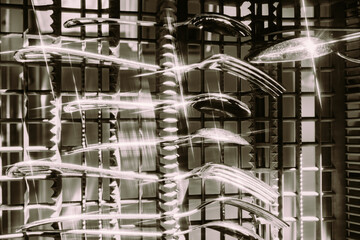 Forks and spoons glisten in bright light