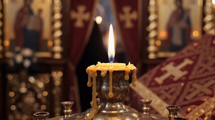 Orthodox Easter Vigil background with single candle glowing in dark church interior