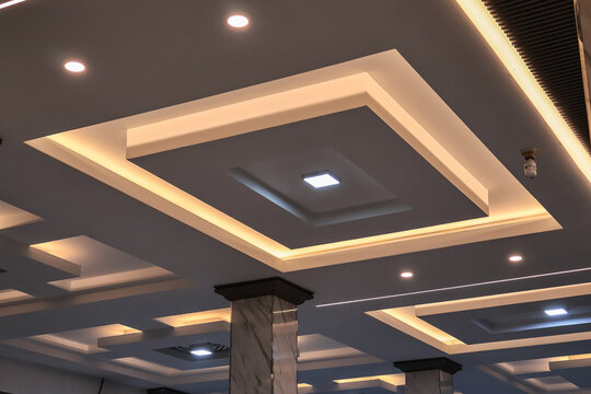 Ornate Ceiling Design with Geometric Patterns and Cove Lighting Creates a Luxurious Ambiance, Ideal for High-End Interior Design Projects